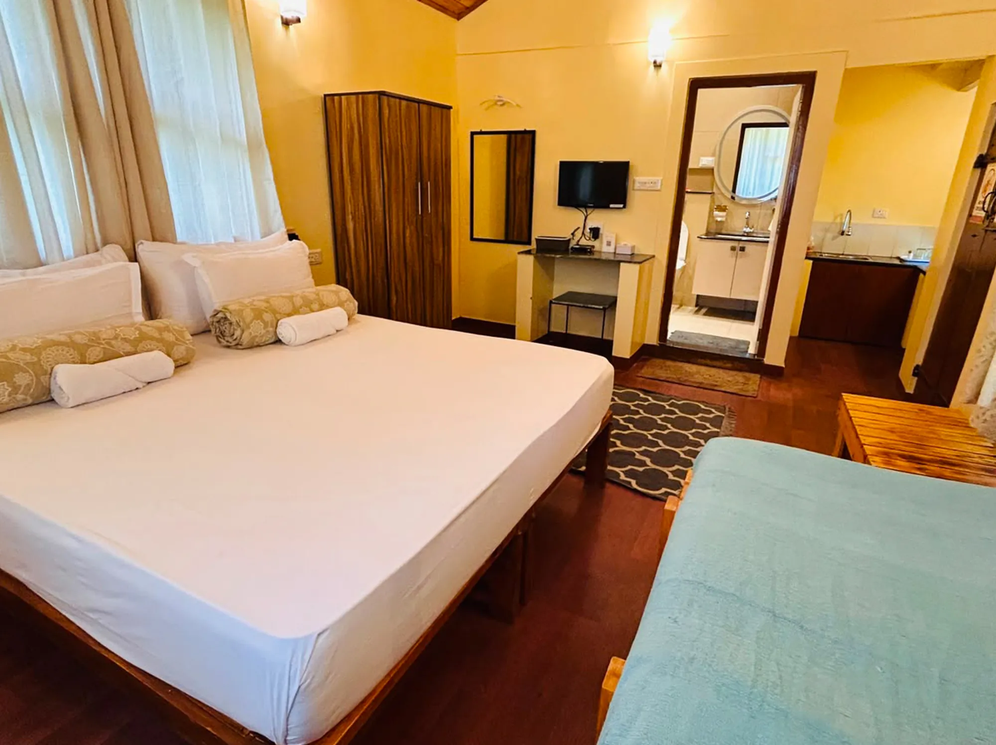 Queen bed in a serene mountain sanctuary with panoramic hill views